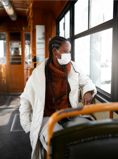 Woman in white coat on public transport
